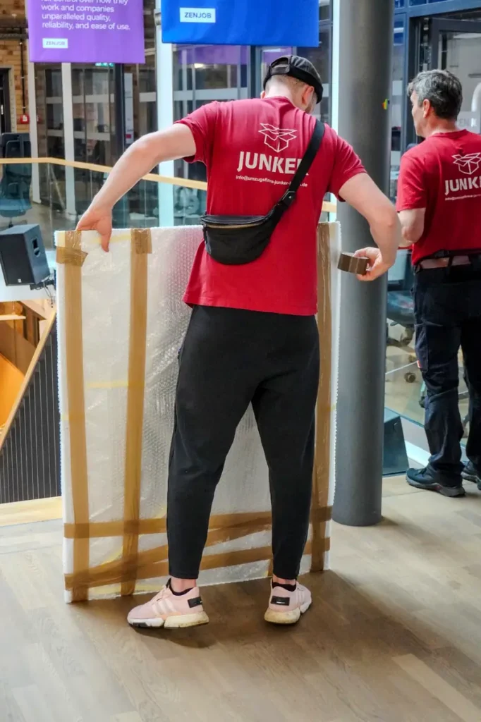 Mitarbeiter der Junker Umzugsfirma GmbH verpackt ein Bild sicher für den Transport in Berlin