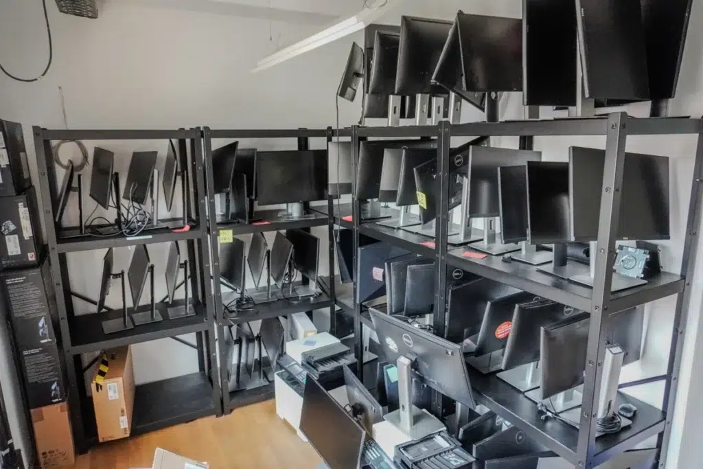 Eingelagerte Computerbildschirme und IT-Equipment in Regalen für einen Firmenumzug